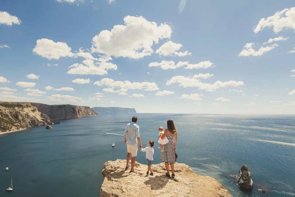 Family on vacation enjoying the scenic view of the sea.
